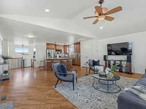 Living area with ceiling fan, light wood finished floors, plenty of natural light, and recessed lighting