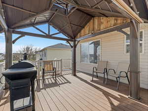 Deck with a grill and a residential view