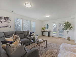 Living room featuring french doors and carpet