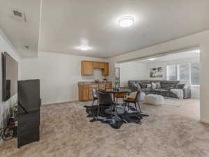 Dining room featuring light carpet and baseboards