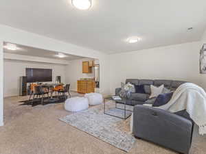 Living room with light colored carpet and a desk