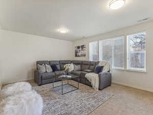Living room with carpet flooring and baseboards