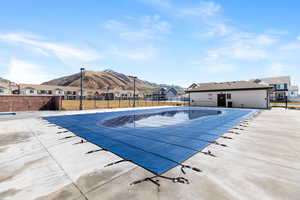 Community pool featuring a residential view, a patio area, and a mountain view