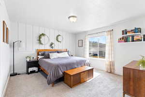 Bedroom featuring light colored carpet and baseboards