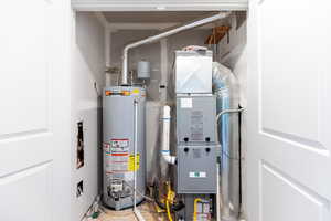 Utility room featuring water heater