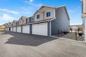 View of home's exterior featuring a residential view and community garages