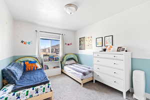 Bedroom featuring light colored carpet