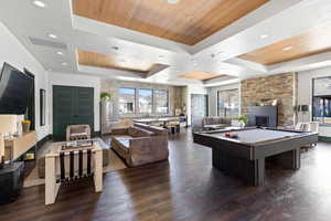 Recreation room featuring billiards, a wooden tray ceiling, a fireplace, and recessed lighting