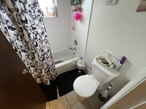 Bathroom featuring shower / tub combo and light tile patterned floors