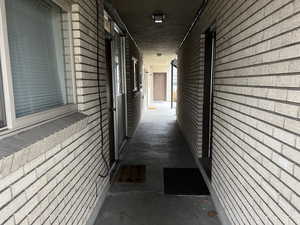 Corridor with brick wall and concrete flooring