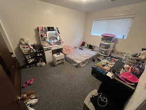 Bedroom featuring carpet flooring and a textured ceiling