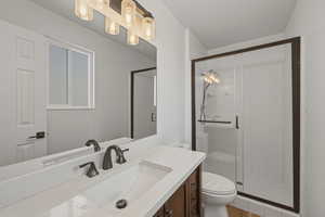 Bathroom featuring vanity and a stall shower
