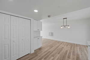 Unfurnished dining area with light wood-style flooring and recessed lighting