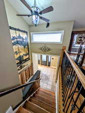 Stairs featuring ceiling fan and tile patterned floors