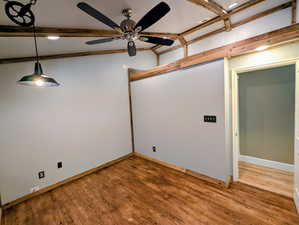 Spare room featuring light wood-type flooring, a ceiling fan, recessed lighting, and lofted ceiling