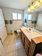 Bathroom with vanity and light tile patterned flooring