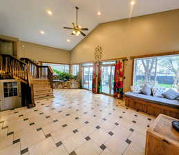 Living room with a ceiling fan, recessed lighting, and lofted ceiling