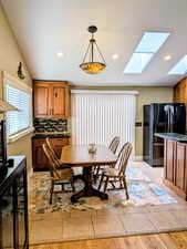 Dining room with a skylight and recessed lighting