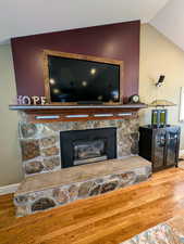 Detailed view of wood finished floors and a fireplace