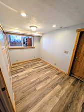 Unfurnished bedroom with a textured ceiling, light wood-style flooring, and recessed lighting