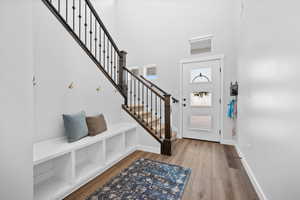 Foyer featuring light wood-style flooring and a high ceiling