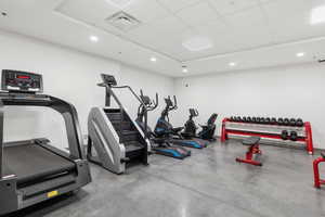 Gym with a paneled ceiling and recessed lighting