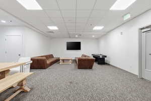 Club  room featuring carpet and a drop ceiling