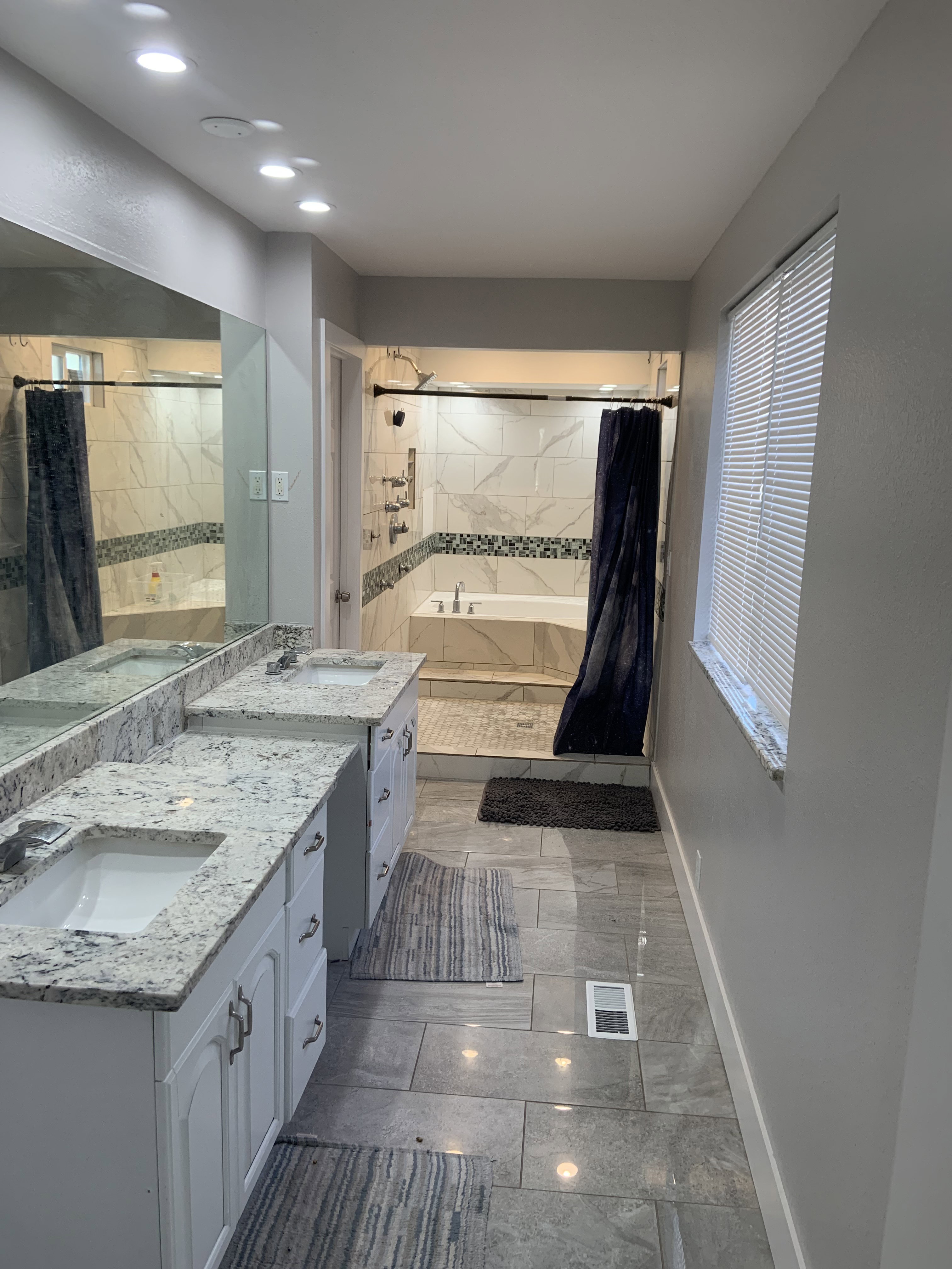 Dual white vanity with granite countertops and undermount sinks