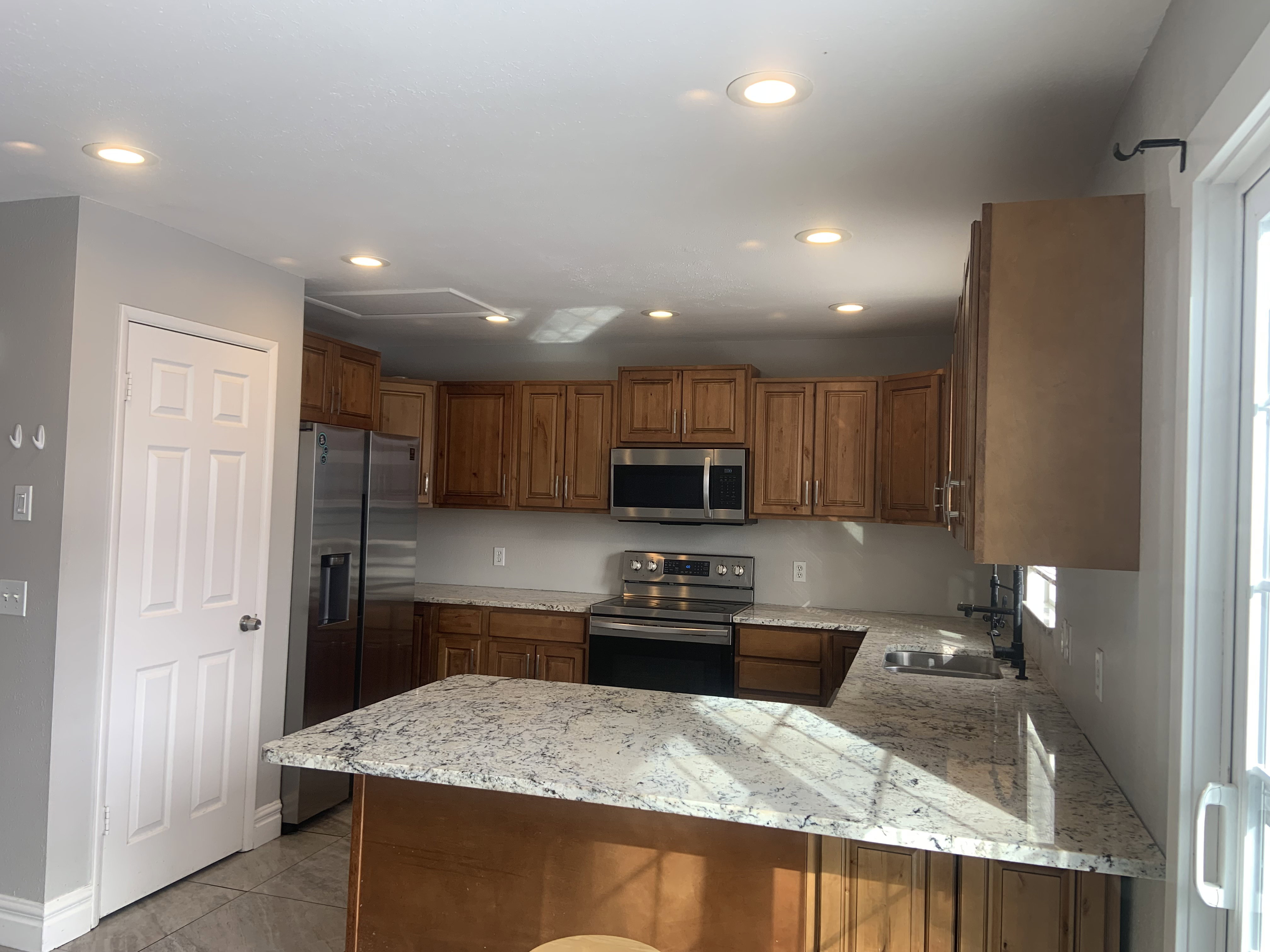 Kitchen featuring wood cabinetry, stainless steel appliances, and light-colored countertops