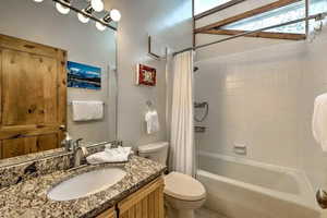 Bathroom featuring vanity and shower / tub combo with curtain