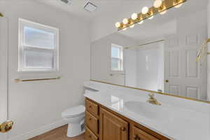 Bathroom featuring vanity, light wood-style flooring, and a shower with curtain