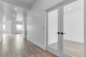 Hall featuring light wood finished floors and recessed lighting