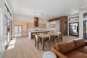 Dining space with light wood-style flooring and recessed lighting