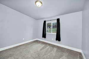Spare room featuring light carpet and a textured ceiling