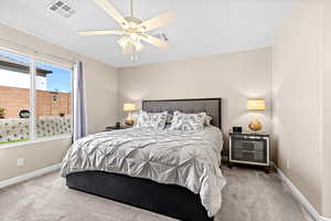 Bedroom with a ceiling fan and carpet flooring