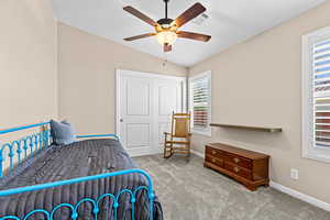 Bedroom featuring lofted ceiling, carpet, a ceiling fan, and a closet