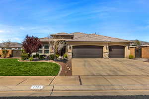 Prairie-style home featuring a gate, stucco siding, concrete driveway, and stone siding