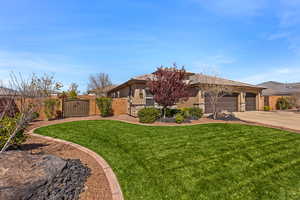 Prairie-style house featuring a gate, stucco siding, concrete driveway, an attached garage, and stone siding