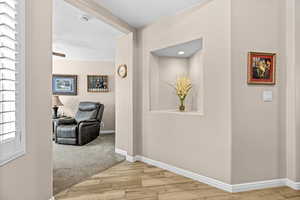 Corridor featuring light wood finished floors and baseboards