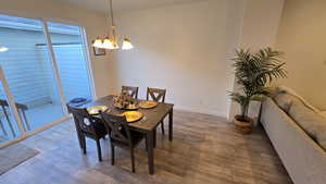 Dining room featuring wood finished floors and hanging lights