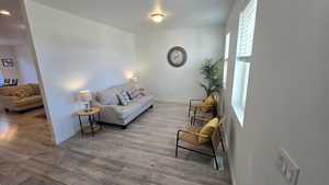 Living area with wood finished floors and baseboards