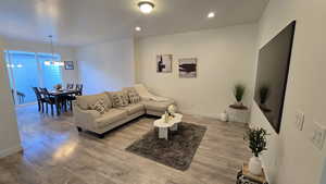 Living area featuring light wood-style floors and recessed lighting