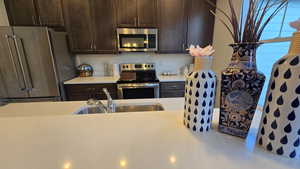 Kitchen featuring dark wood finish cabinets and stainless steel appliances