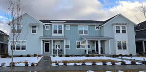 View of front of property with board and batten siding, a standing seam roof, and roof with shingles