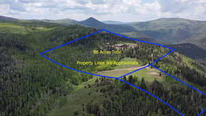 Aerial overview of property's location with a mountainous background and property parcel outlined