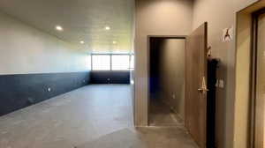Hall with concrete floors and recessed lighting