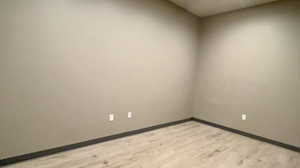 Unfurnished room with light wood-type flooring and baseboards