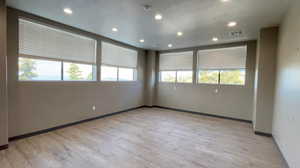 Spare room with light wood-type flooring and recessed lighting