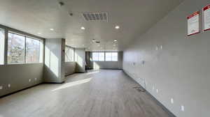 Empty room featuring light wood finished floors and recessed lighting