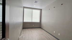 Unfurnished room featuring light wood-style floors and baseboards
